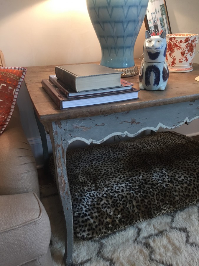 BUNNY WILLIAMS BELIEVES IN MAKING EVERYONE FEEL COMFY - EVEN THE PETS...HENCE THE LEOPARD BED TUCKED UNDER A TABLE - GENIUS!