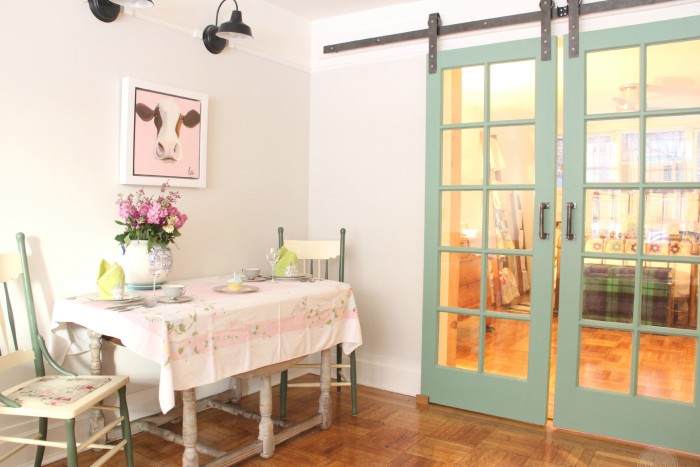 SUZANNE'S LIVING ROOM IS SEPARATED FROM HER BED ROOM BY OLD WINDOWS TURNED INTO BARN DOORS!!!